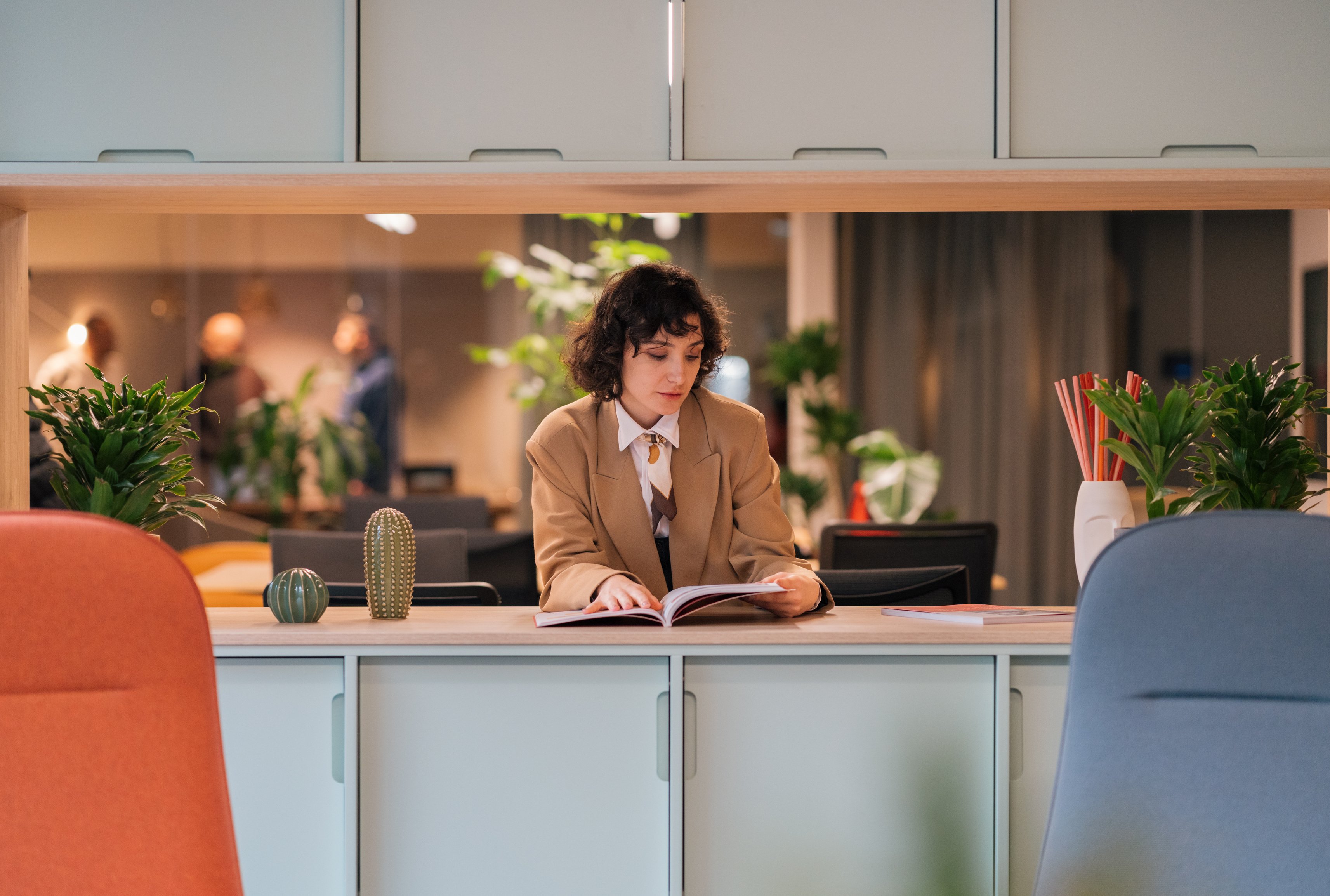 Woman Reading a Book in the Office